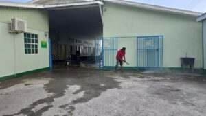IHSAAI members power wash the exterior of Intermediate High School